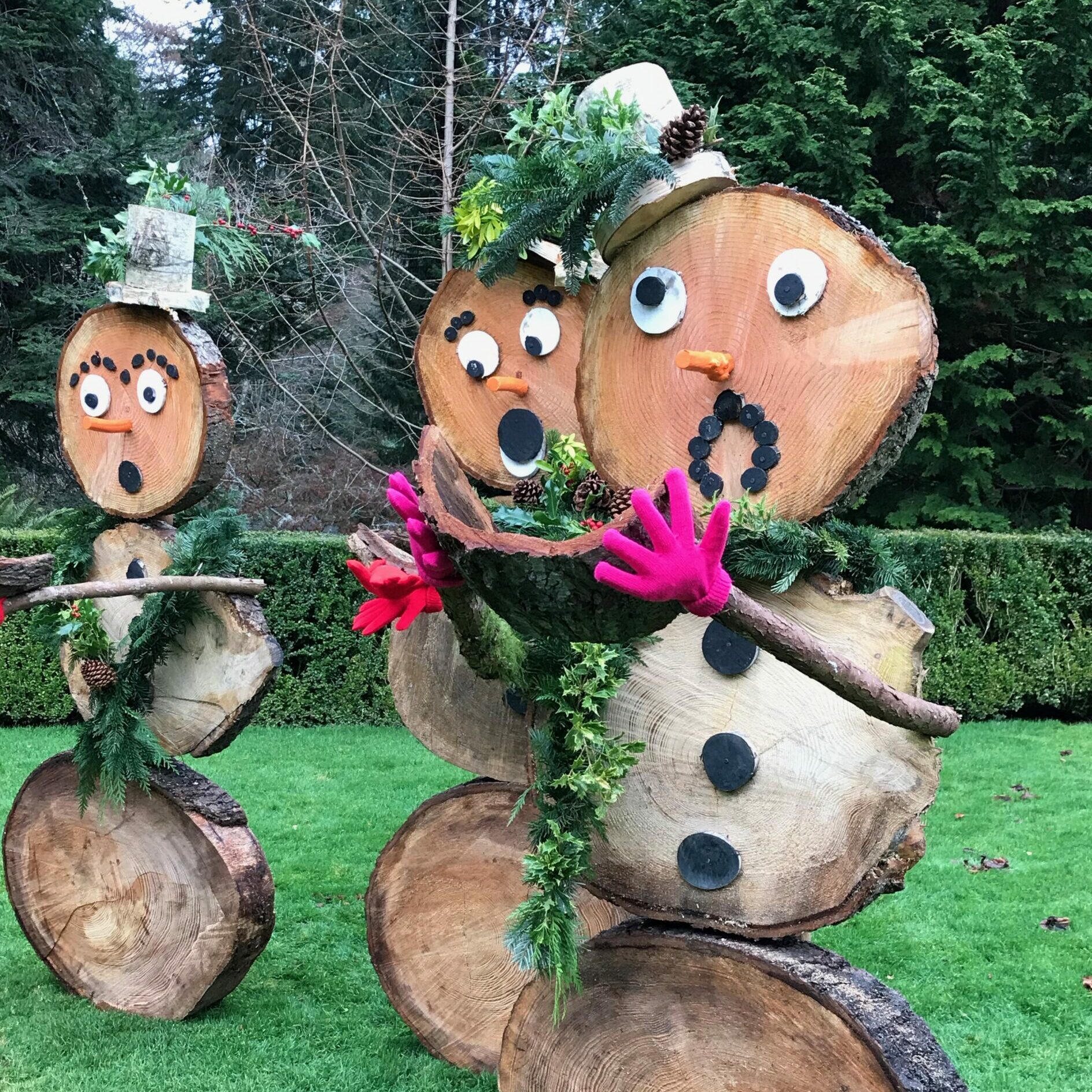 Winter snowpeople made out of logs.
