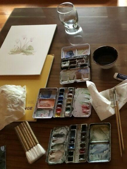 Watercolor painting of flowers and paints