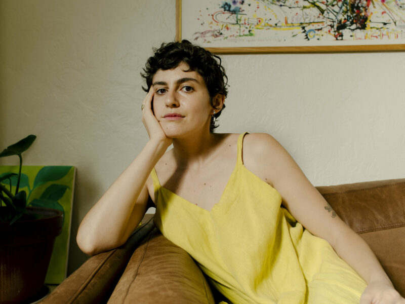 Woman in a yellow top sitting in a chair